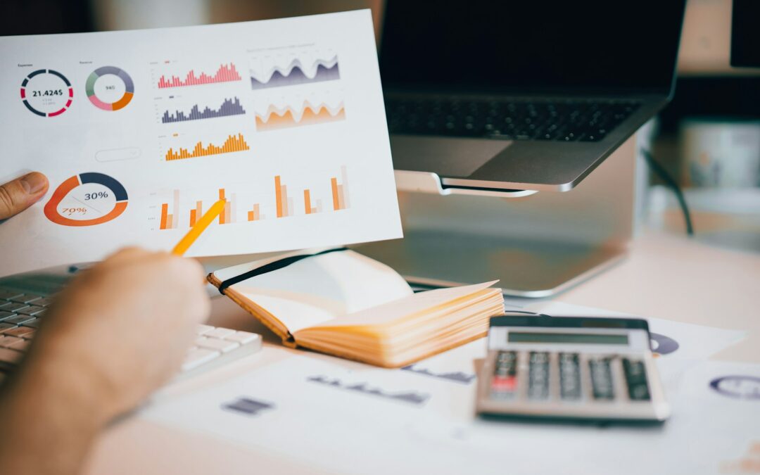a person holding a piece of paper over a laptop